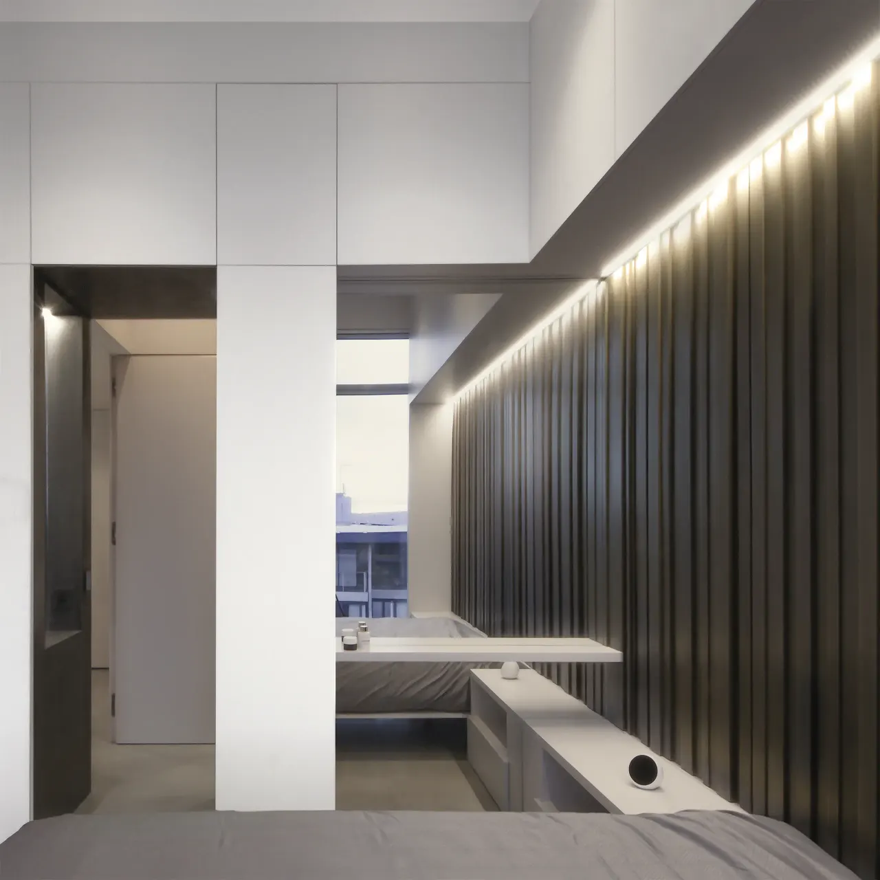 Bedroom with dark vertical panelling, concealed lighting and a window