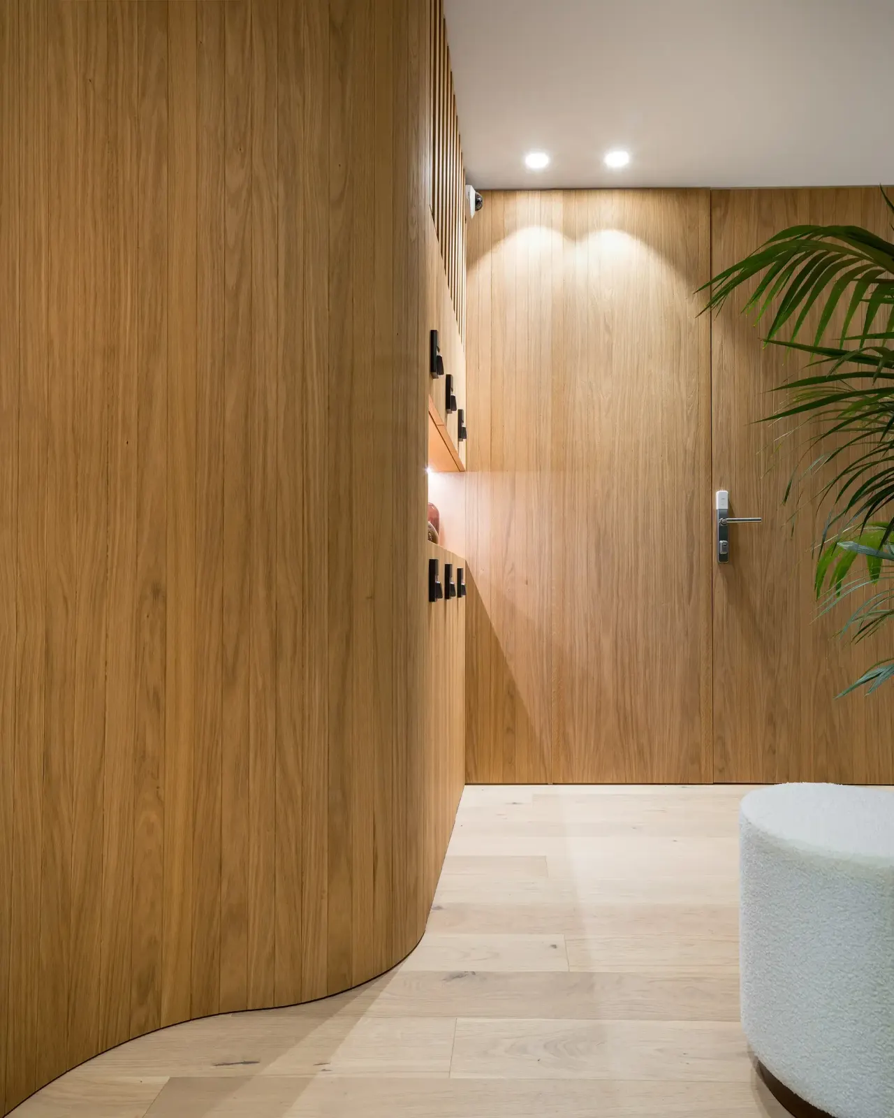 Curved oak-panelled wall in the entrance hall