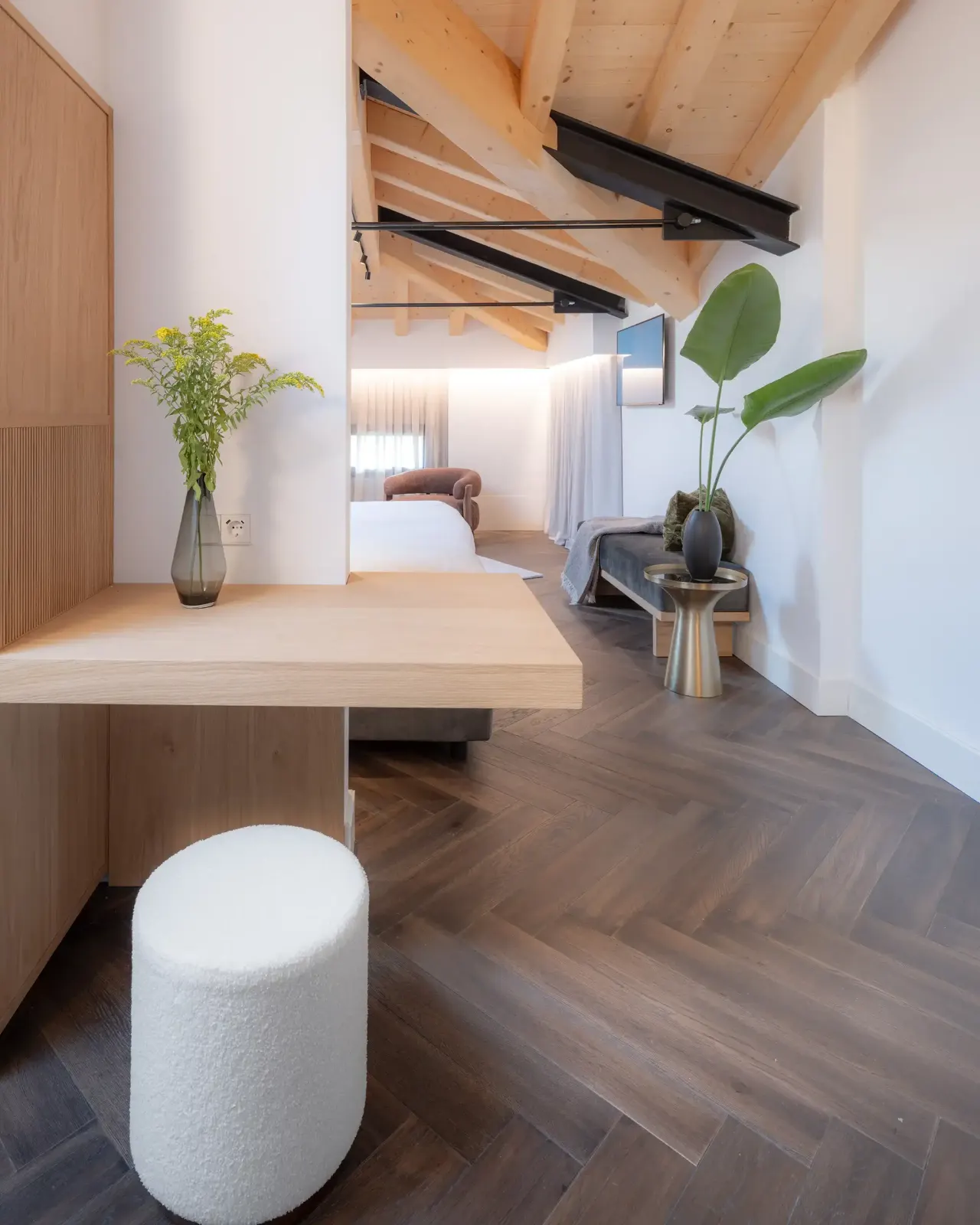 Attic room with exposed timber beams, oak desk and herringbone floor
