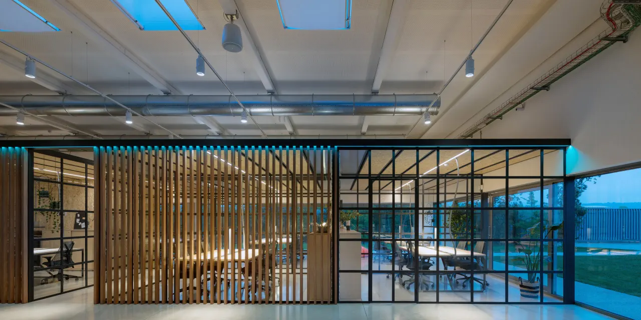 Open workspace with timber-slatted and glazed meeting rooms