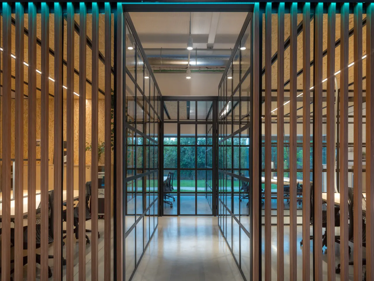 Glazed passage between timber-slatted offices