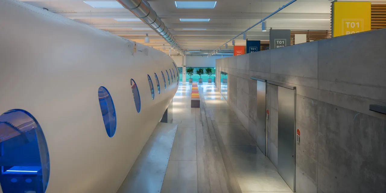 Aircraft fuselage installed inside the campus next to concrete walls