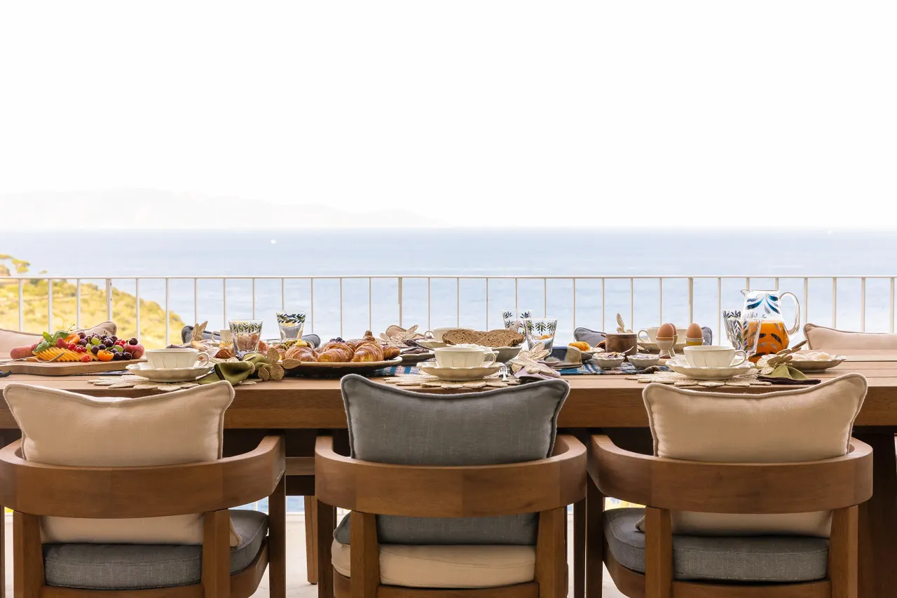 Breakfast table on the terrace overlooking the sea