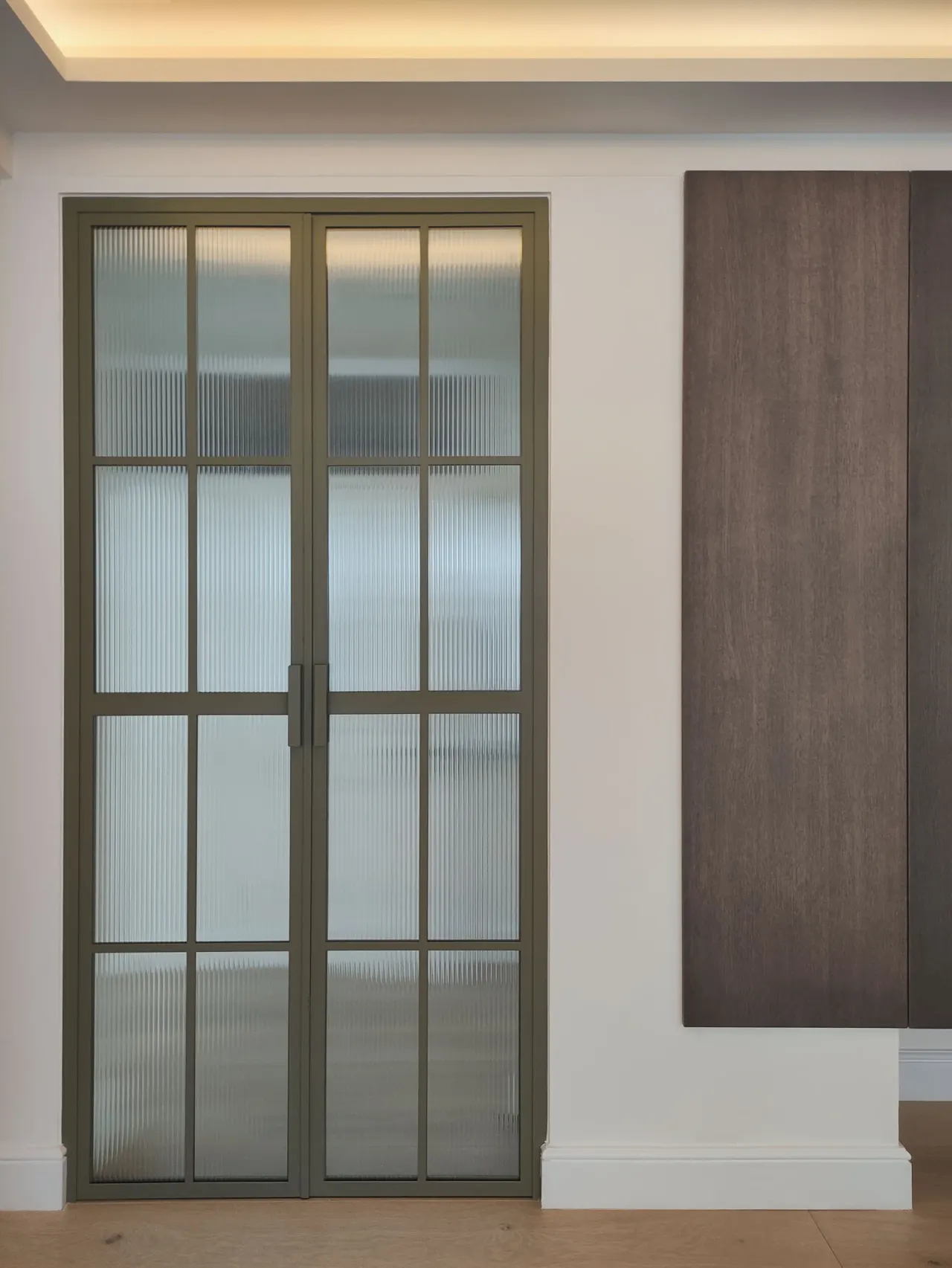 Steel-framed glazed double door with reeded glass