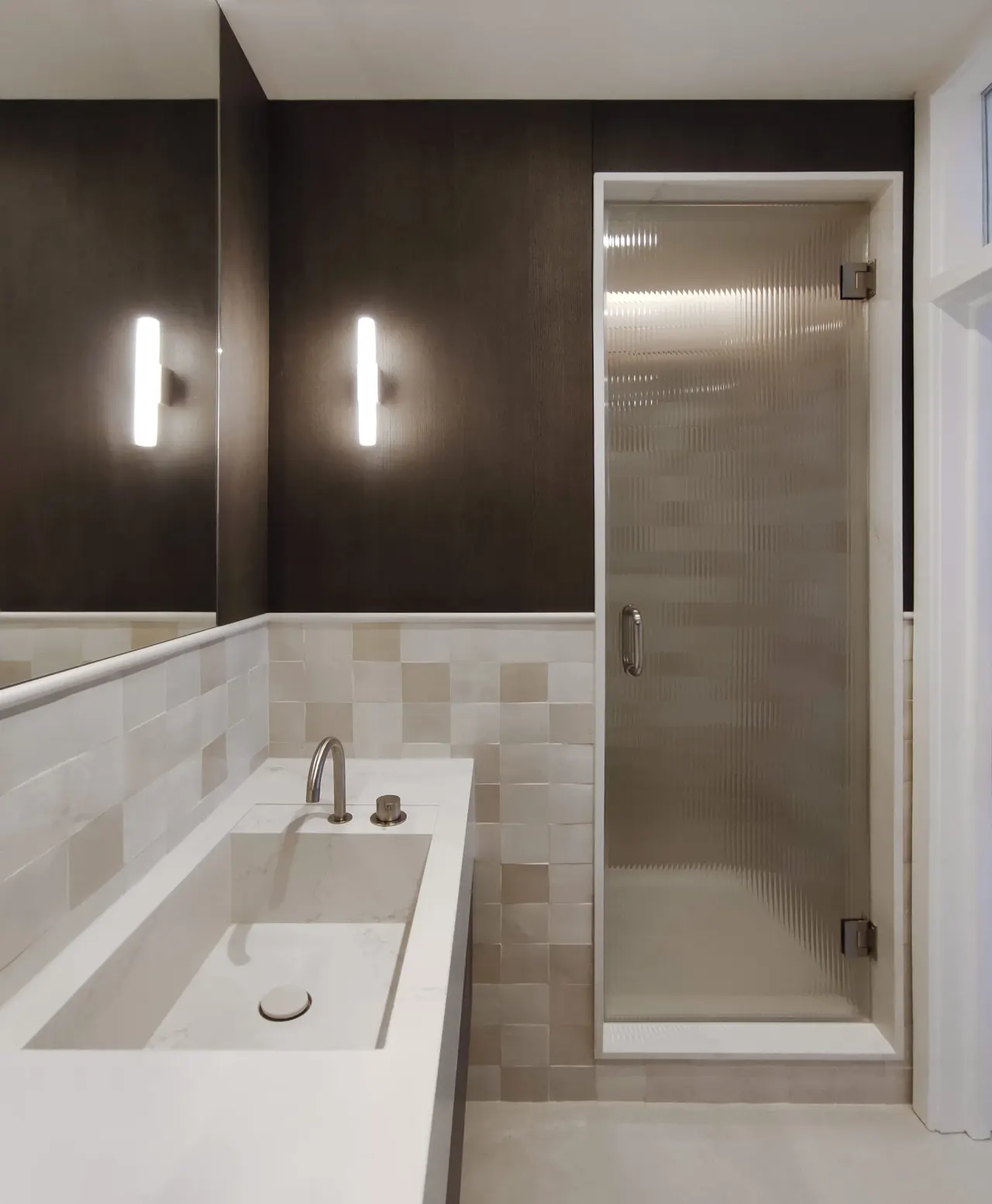 Bathroom with stone washbasin, glass shower door and dark oak panelling