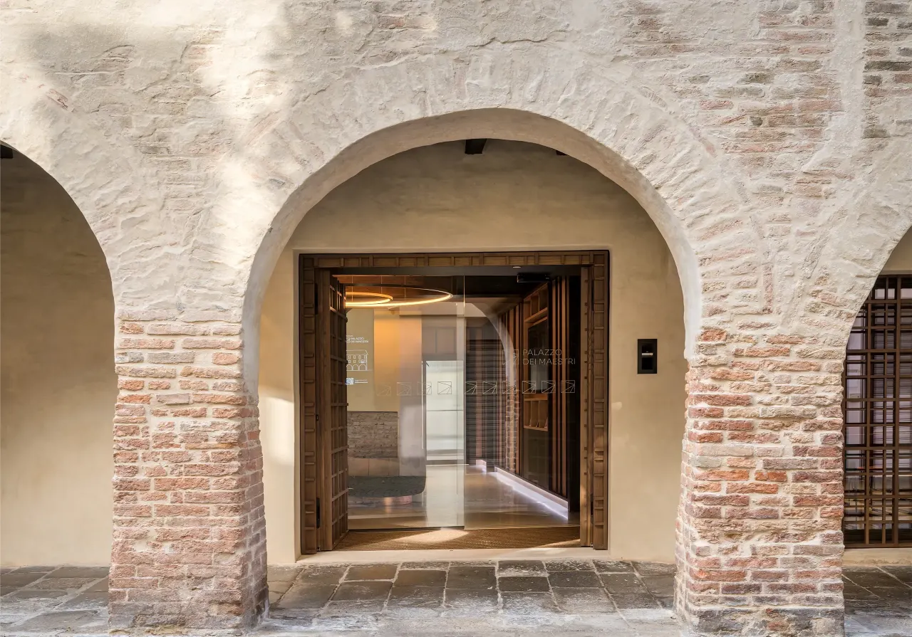 Brick arcade with the glazed entrance to the offices