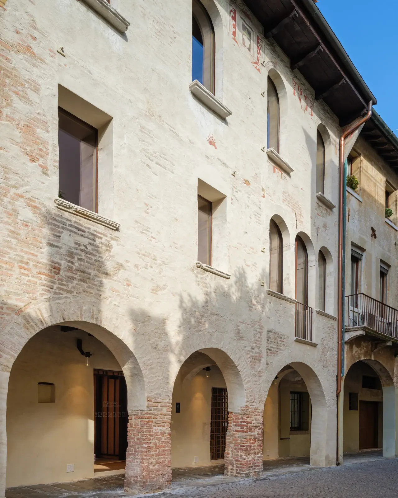 Historic facade with a ground-floor portico along the street