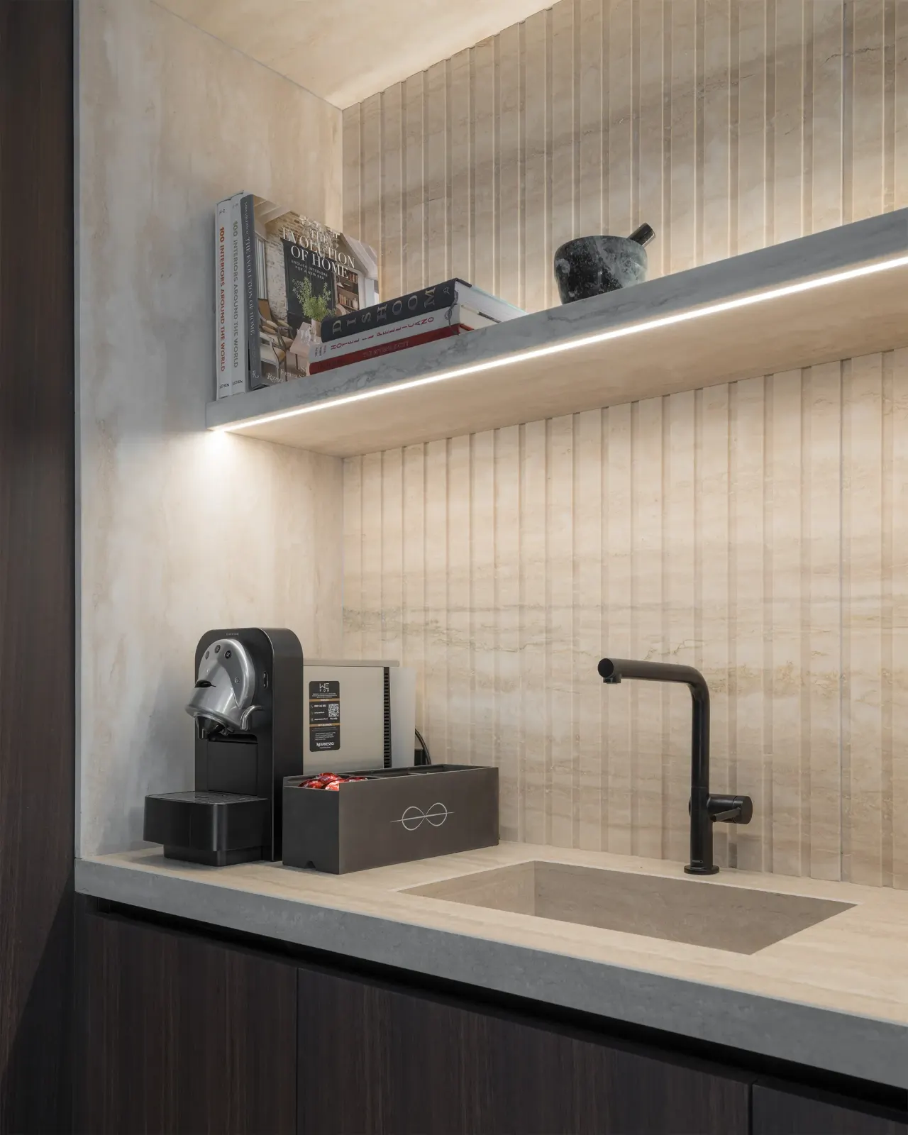 Kitchenette with concrete-effect worktop, black tap and coffee machine