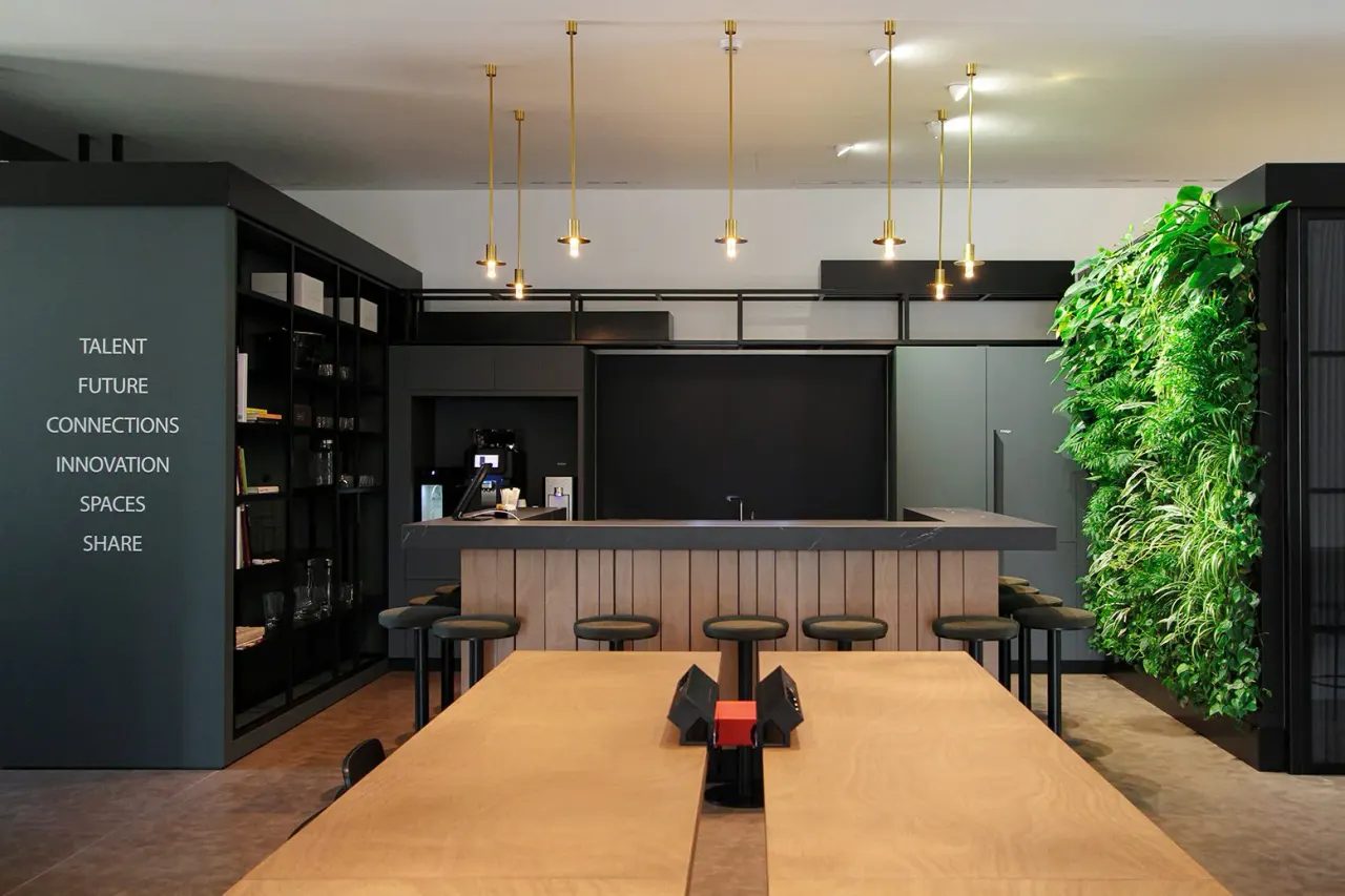 Lounge with long oak table, bar counter and green living wall