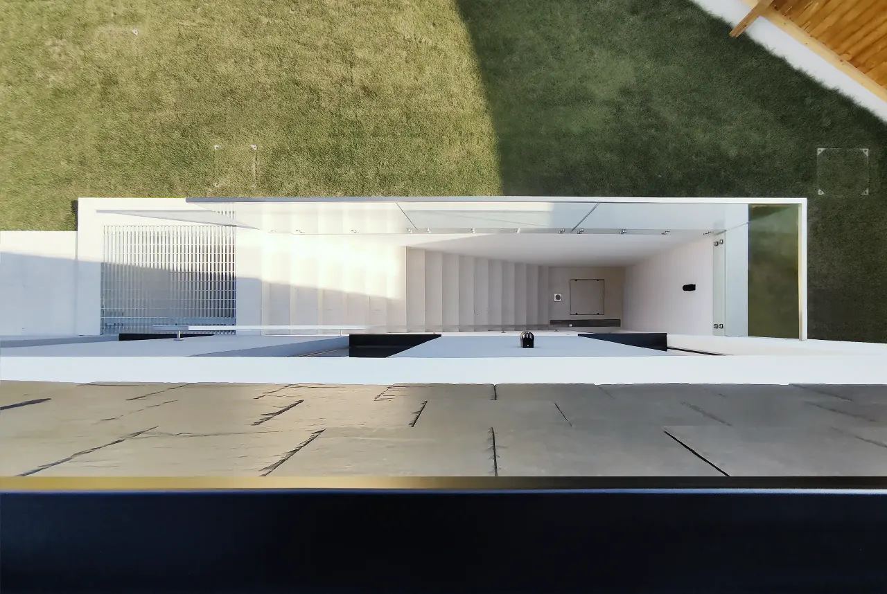 Glazed basement opening set into the grassy bank